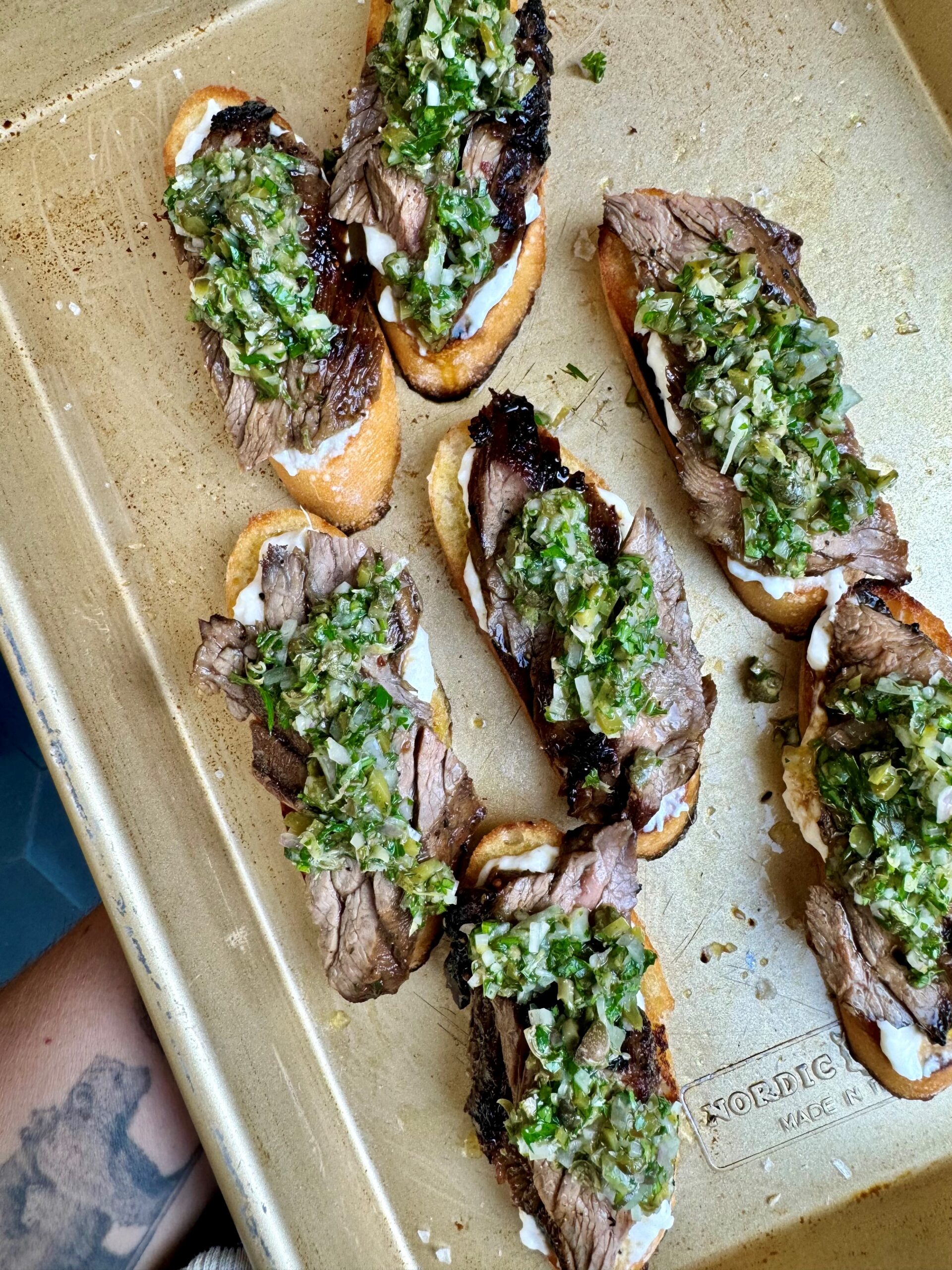 A Taste of the Holidays: Gourmet Recipes from Culinary Stars, Cookbook Authors & Celebrity Chefs -Skirt Steak Burrata Crostini by Brooke Williamson