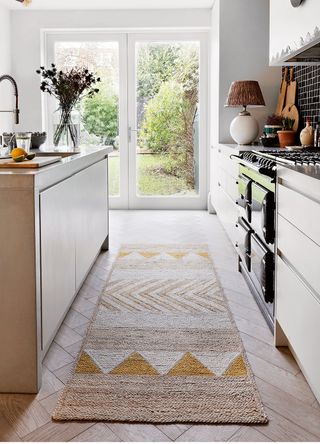 A kitchen with a woven runner to show how to make a kitchen cosy