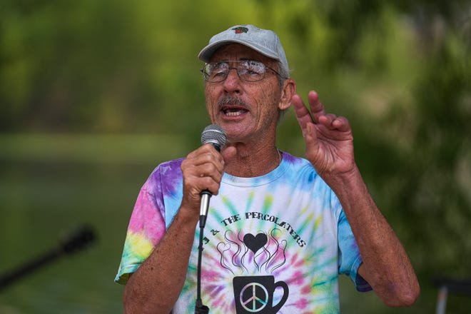 PJ Liles, a musician and activist, speaks at a memorial service at Auditorium Shores on Sunday, Nov. 17, 2024 in Austin. Advocates and members of the homeless community gathered to honor the more than 200 homeless people that died between September of 2023 and November of 2024.