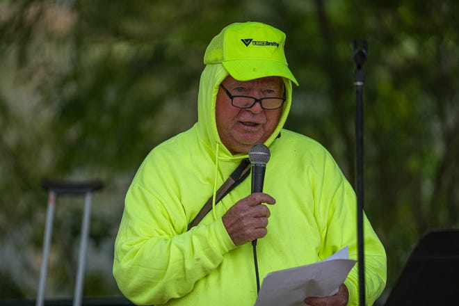 Thom Woodruff, a poet and activist, reads a poem at a memorial service at Auditorium Shores on Sunday, Nov. 17, 2024 in Austin. Advocates and members of the homeless community gathered to honor the more than 200 homeless people that died between September of 2023 and November of 2024.