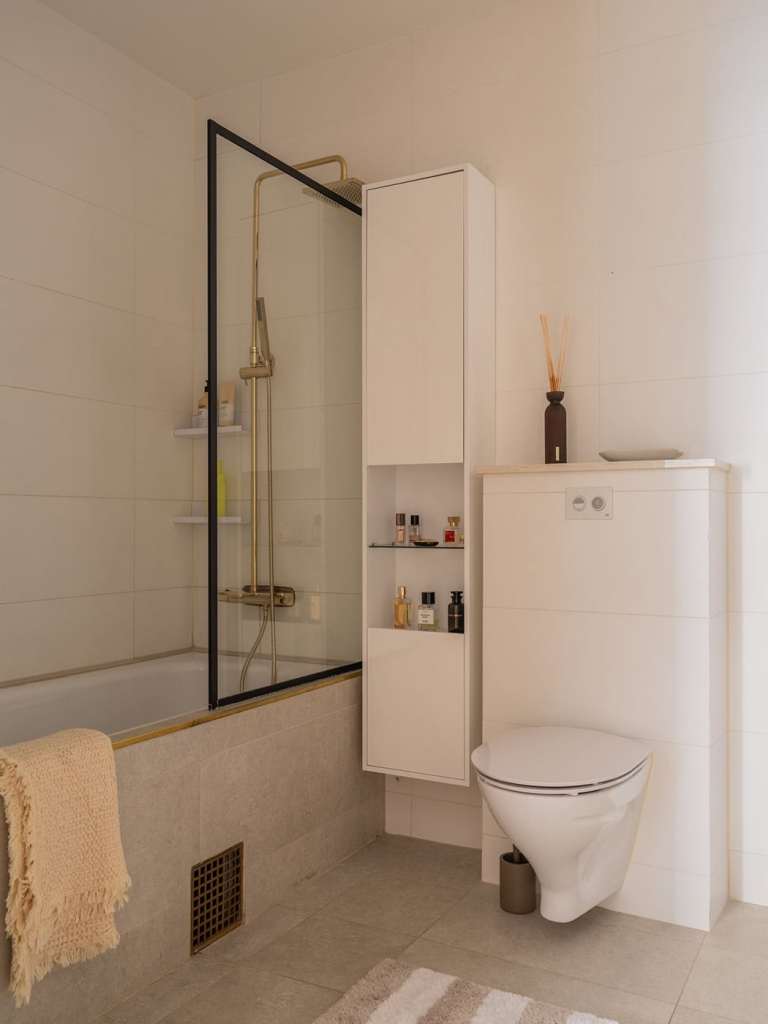 A simple bathroom with gold fixtures