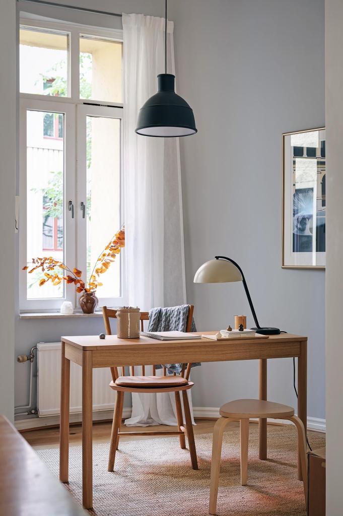 A small home office spot in a room with curved grey walls