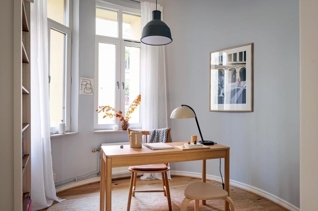 A small home office spot in a room with curved grey walls