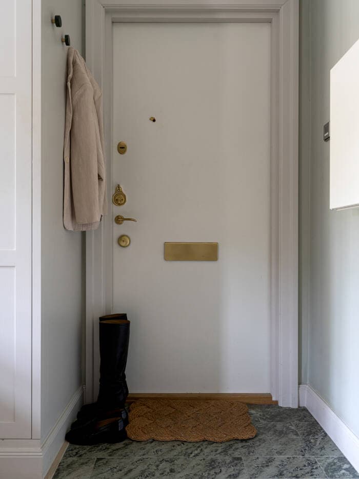 A small hallway with a grey marble floor