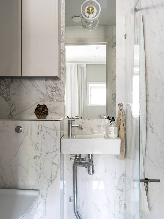 A small white marble bathroom