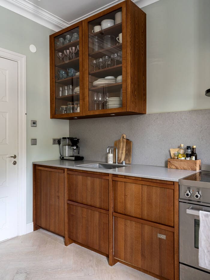 A small studio apartment with a walnut kitchen