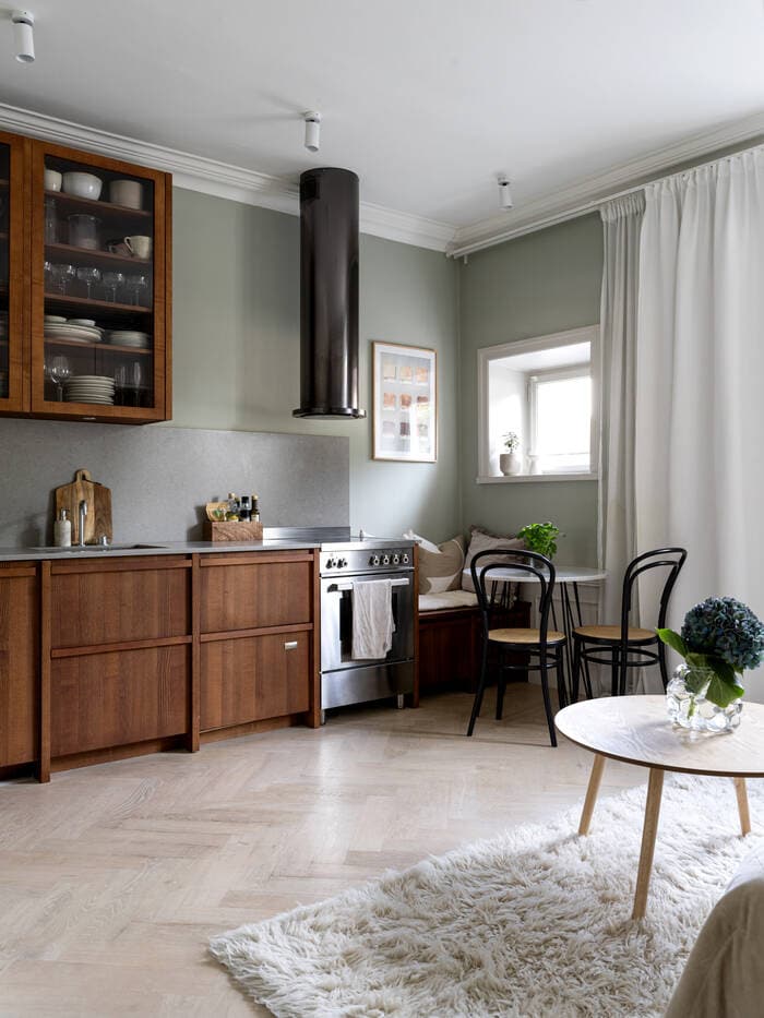 A small studio apartment with a walnut kitchen