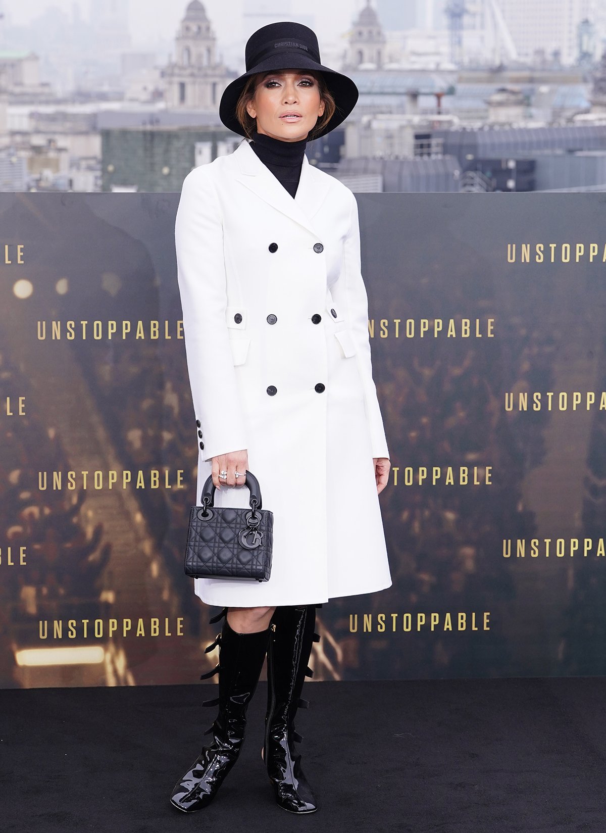 Jennifer Lopez channels the British royal in a white Dior double-breasted coat and a black turtleneck top