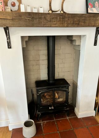 black Esse log burning stove with quarry tile hearth