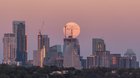 Today’s super moon rising and setting over the skyline