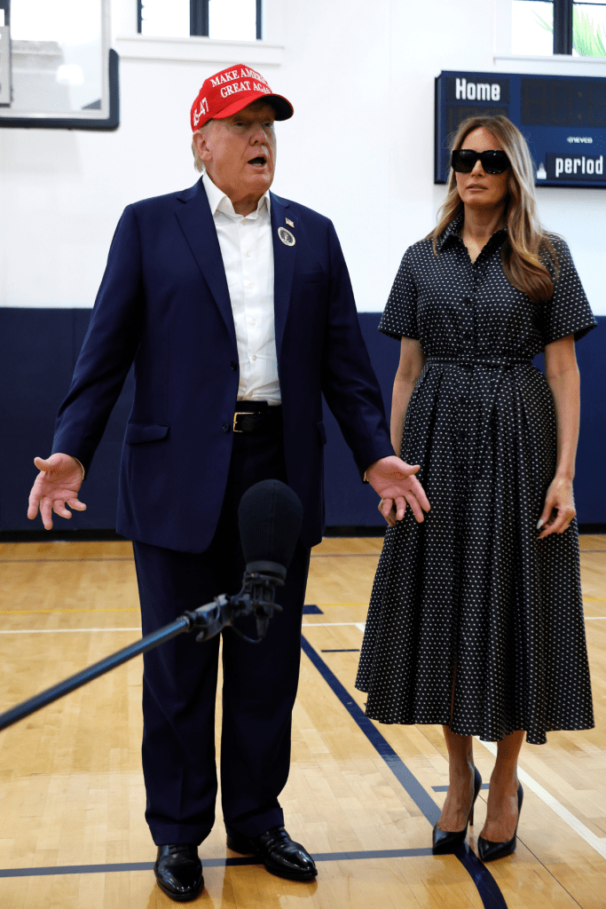 Republican presidential nominee former President Donald Trump and his wife Melania Trump talk to reporters after casting their votes at the polling place in the Morton and Barbara Mandel Recreation Center on Election Day, on November 05, 2024 in Palm Beach, Florida.