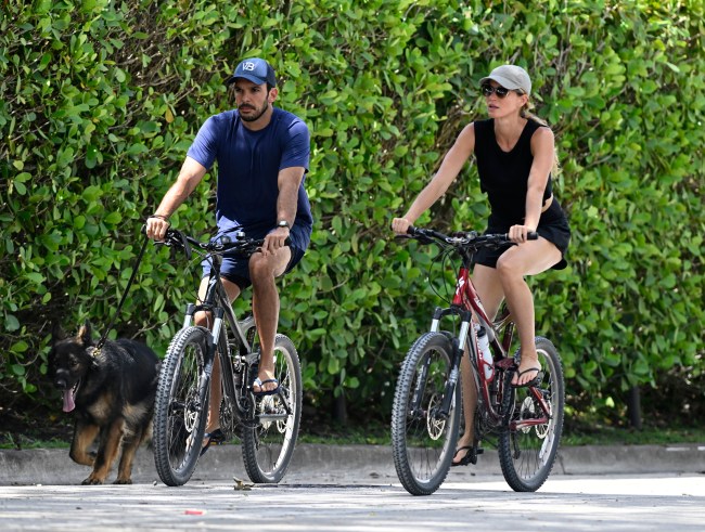 SURFSIDE, FL - JULY 14: Joaquim Valente and Gisele Bündchen are seen on a bike ride on July 14, 2024 in Surfside, Florida.