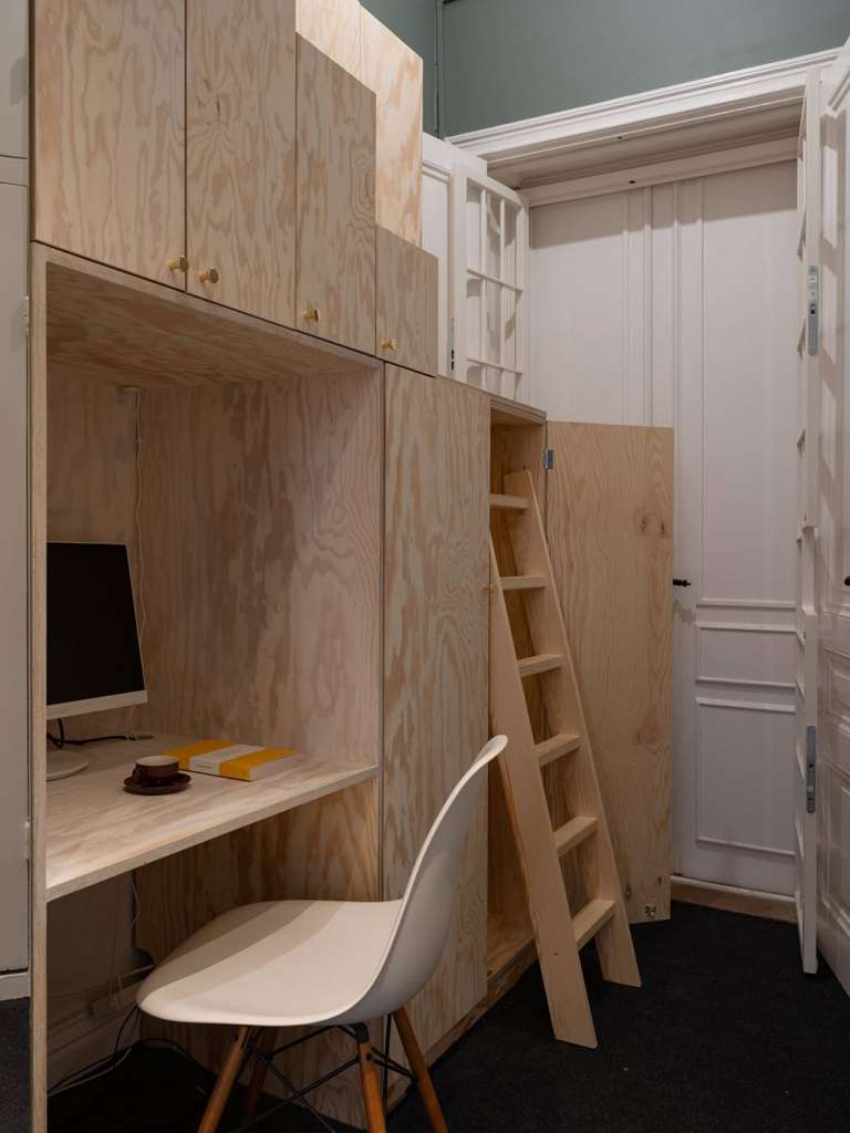 A hallway desk made inside of a custom plywood solution offering lots of hallway storage space