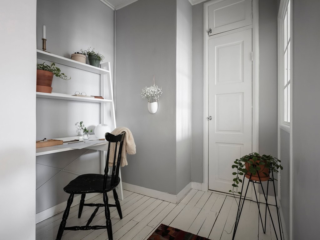 A Narrow Task Desk and Statement Chair in a Tiny hallway Space