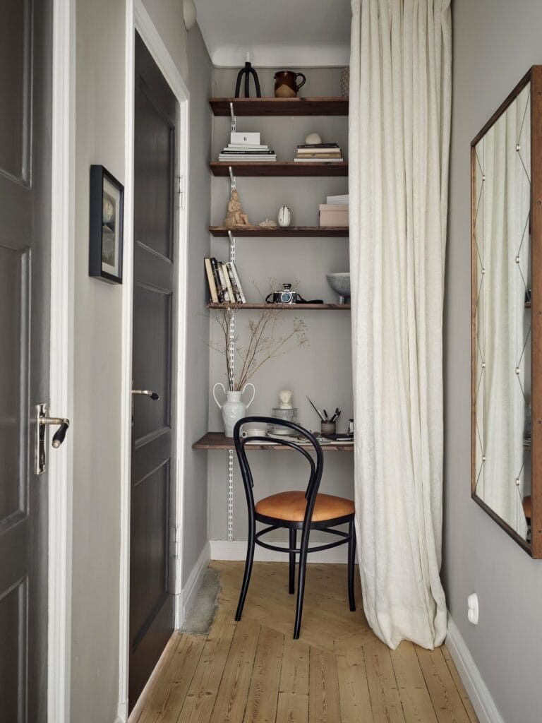 An End-of-the-Hallway Desk Nook Made of Floating Shelves in dark stained wood