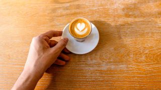 Cortado in small glass with saucer underneath