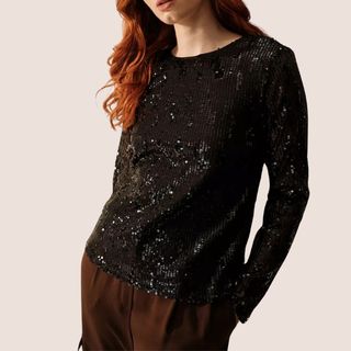 flat lay image of woman wearing glittery top