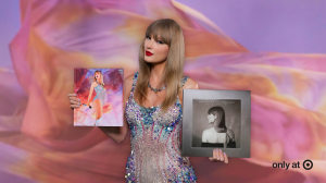 Taylor Swift holding The Eras Tour Book and The Tortured Poets Department: The Anthology vinyl, both Target exclusives.