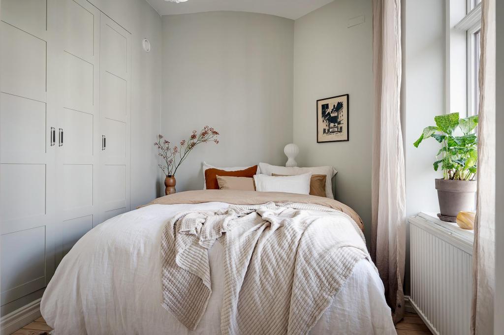 A simple wardrobe built into the wall of a bedroom with subtle grey walls