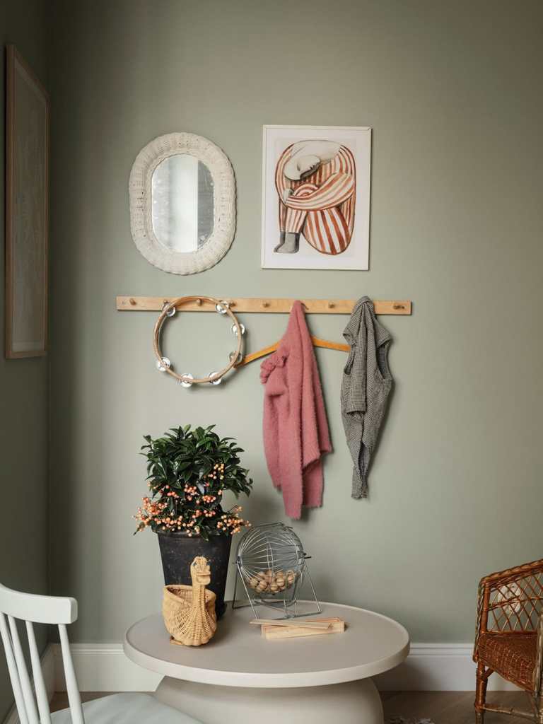 A kid's room with sage green walls