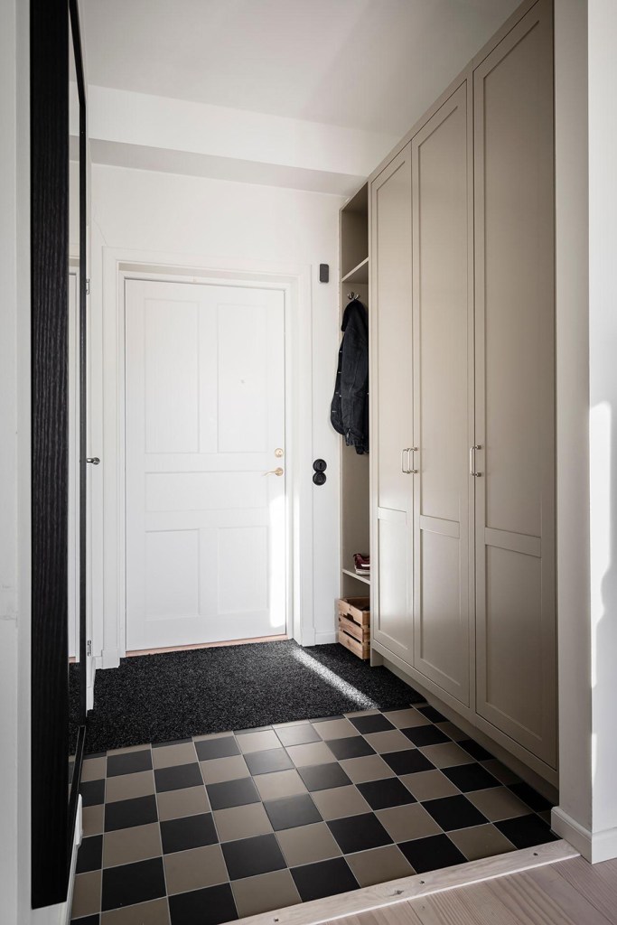 A custom hallway wardrobe with closed and open storage