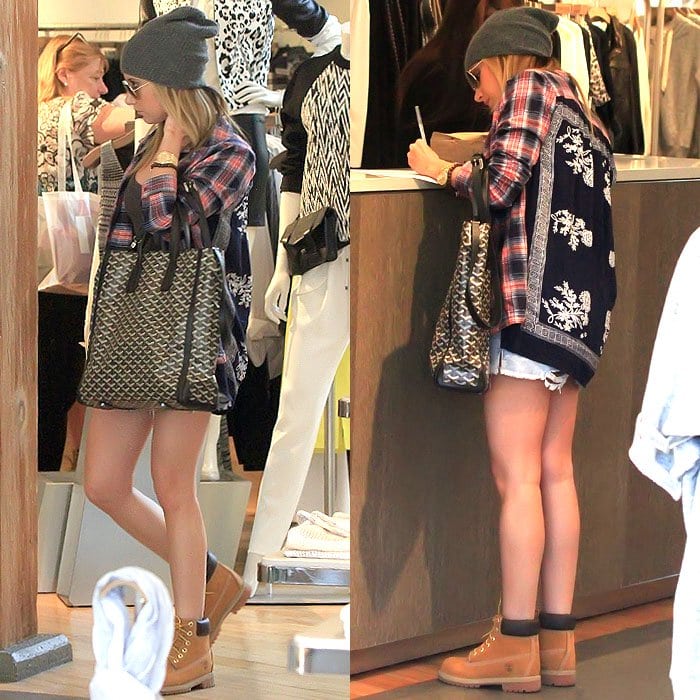 Ashley Tisdale nails casual chic with Timberland boots, distressed denim shorts, a plaid shirt, a patterned cardigan, and a slouchy beanie for a laid-back shopping look