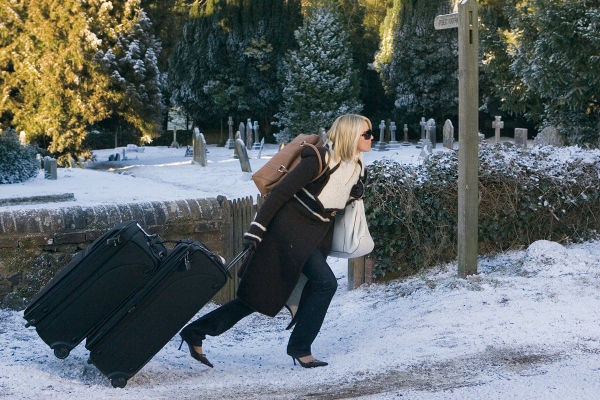 Cameron Diaz, as Amanda in The Holiday, treks through the snow in high heels and a chic Valentino trench coat, embodying both elegance and determination