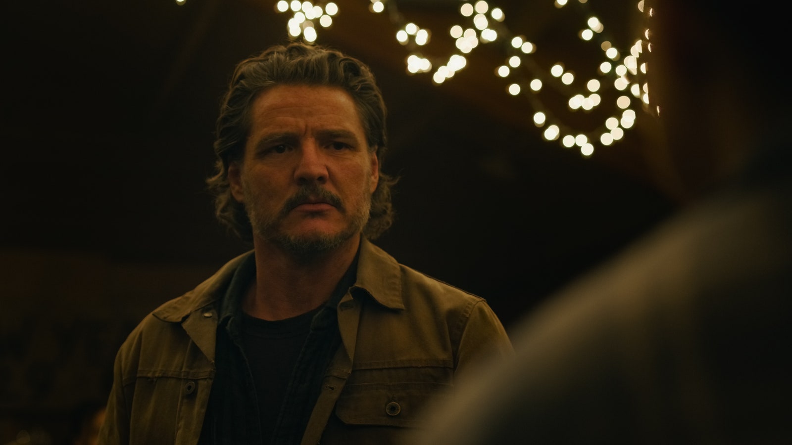 Image may contain Pedro Pascal Lighting Photography Face Head Person Portrait Clothing Coat Jacket and Adult