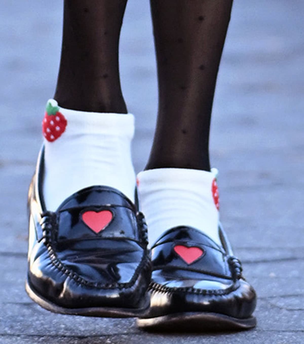 Famke Janssen completes her preppy look by wrapping her long, slim legs in polka-dot stockings and slipping her feet into black G.H. Bass loafers with a red heart accent