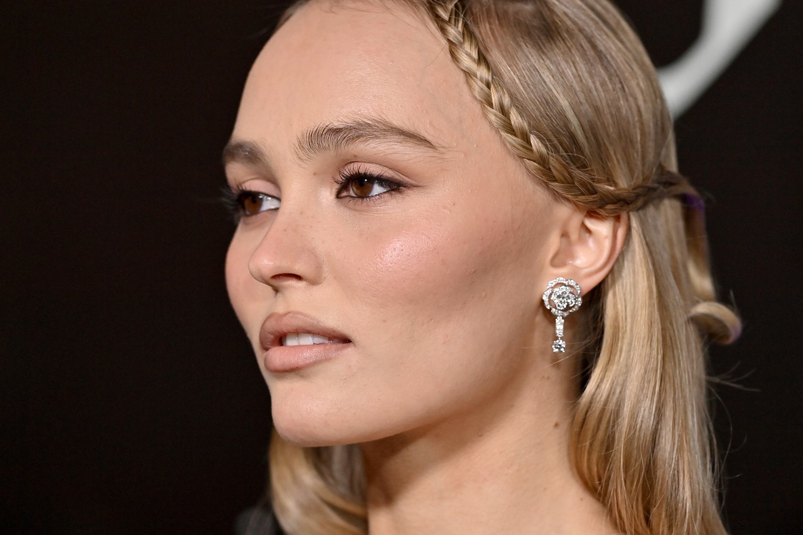 Image may contain LilyRose Depp Accessories Earring Jewelry Adult Person Head Hair and Face