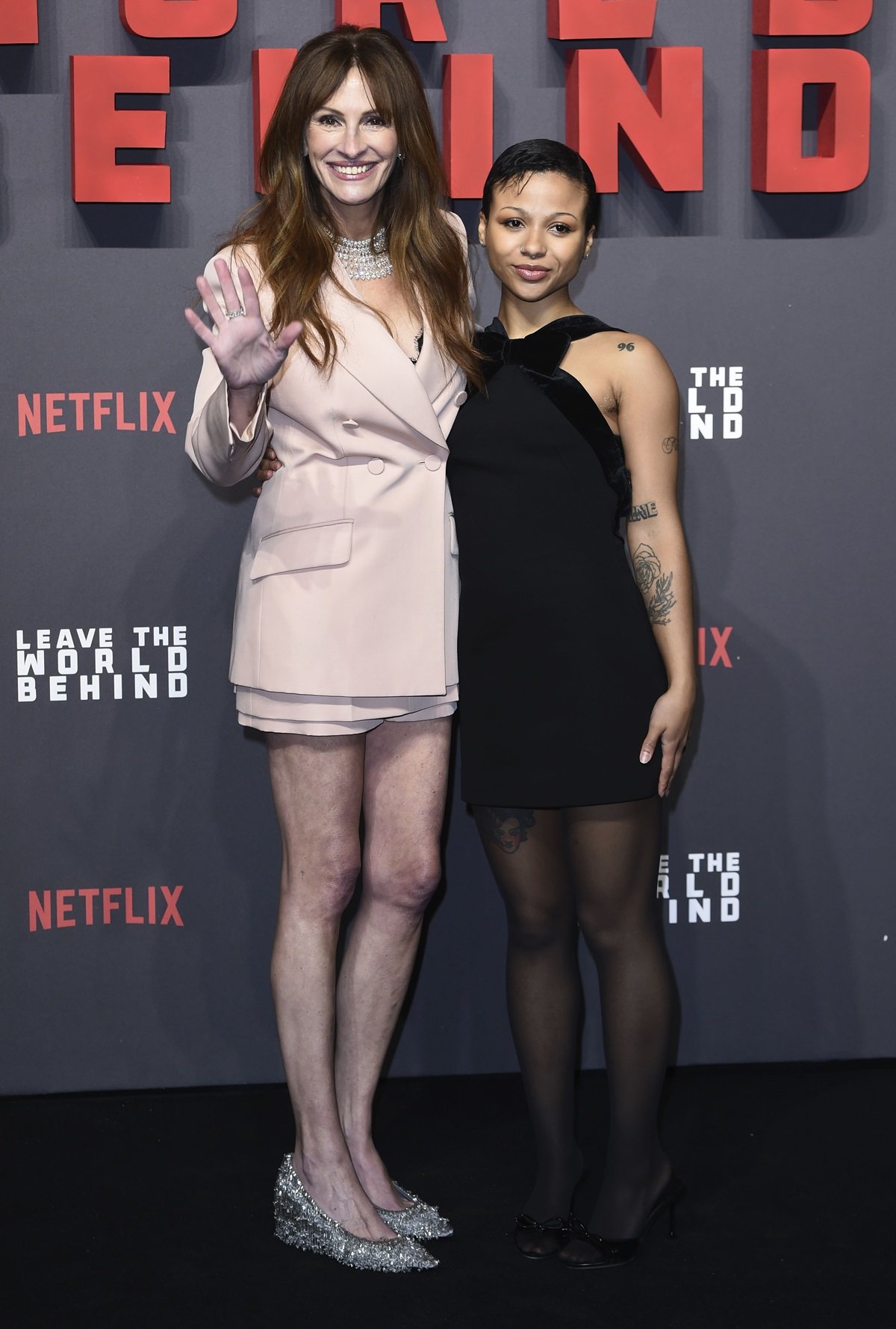 Julia Roberts towers over Myha’la Herrold, with her 5'8" height amplified by sparkling silver heels, highlighting a noticeable height difference on the red carpet