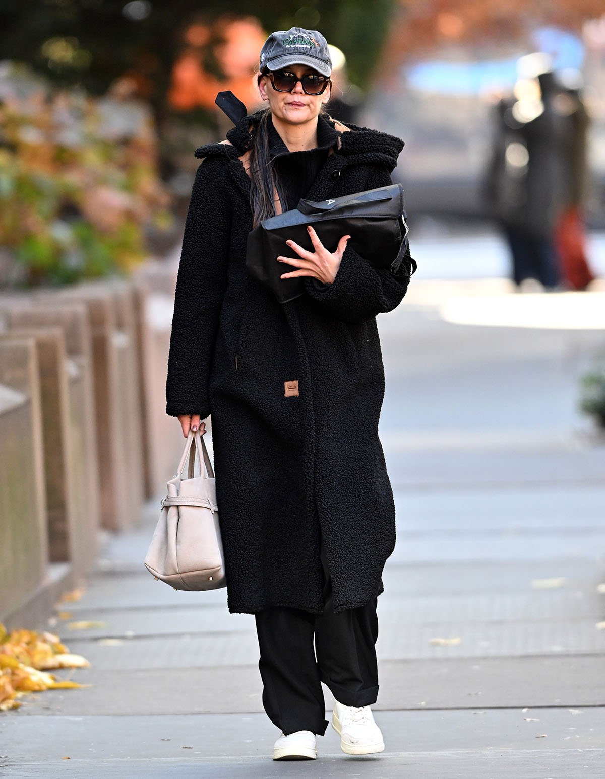 Katie Holmes bundles up in a black faux fur coat by Stand Studio on her way to her Broadway play