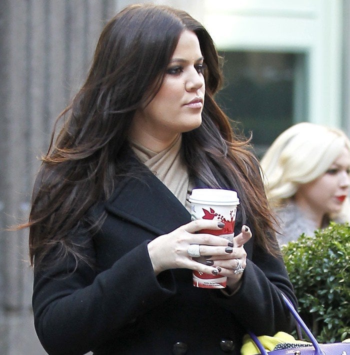 Khloé Kardashian keeps it classic and cozy in a black peacoat dress, accessorized with timeless elegance while strolling in New York on November 29, 2010