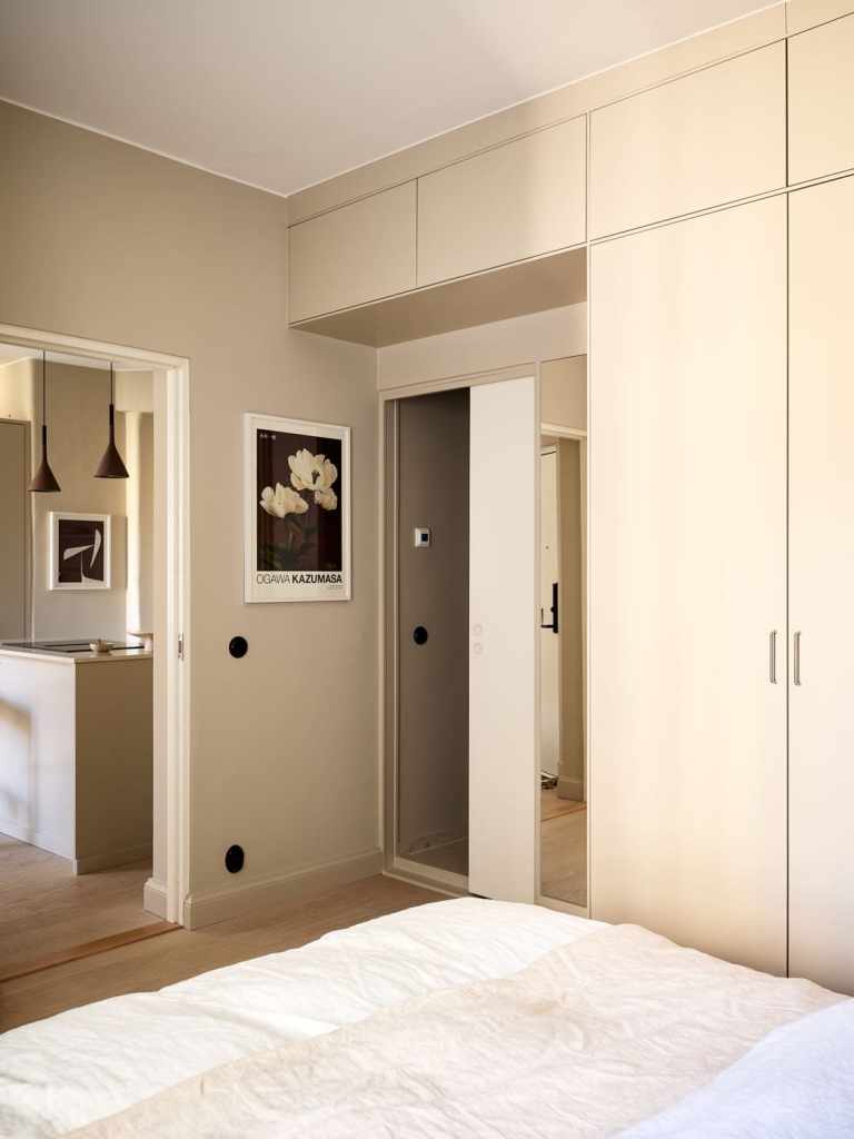 A wall-to-wall wardrobe going over a sliding bedroom door