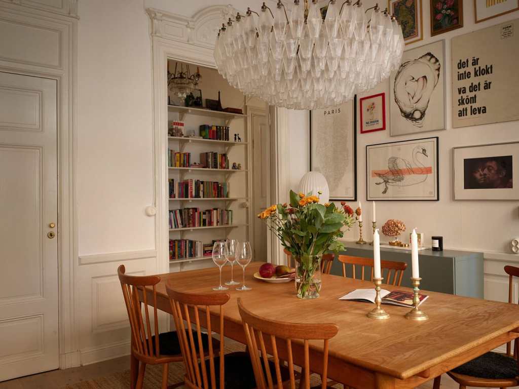 A dining room with a vintage dining table and an impressive gallery wall