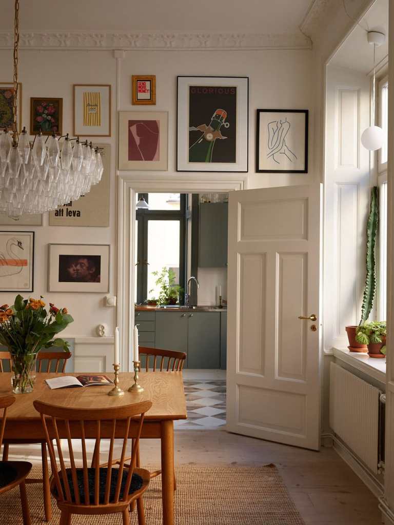 A green kitchen with a checkered floor and partly exposed brick wall