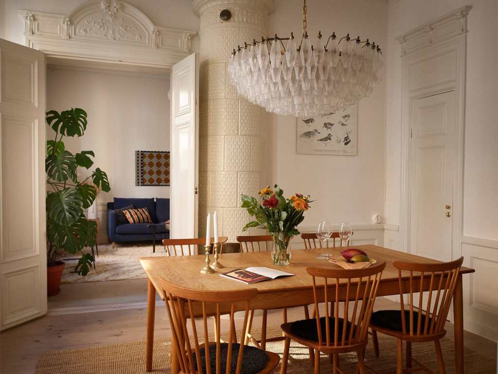 A dining room with a vintage dining table and an impressive gallery wall