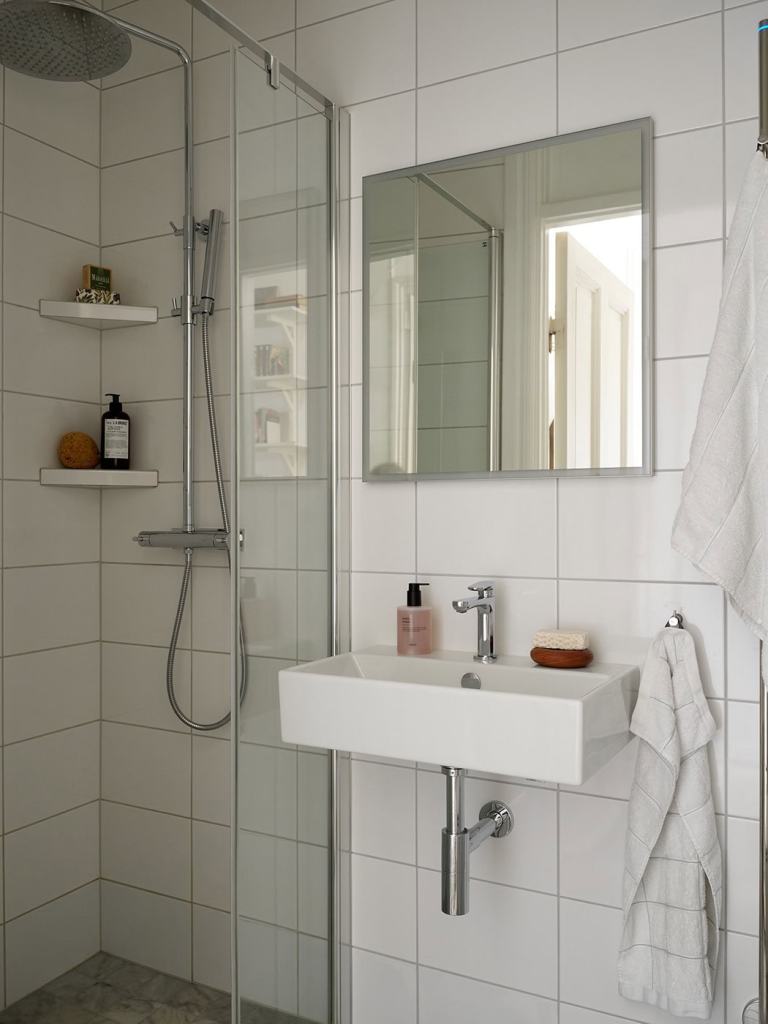 A simple bathroom with white wall tiles