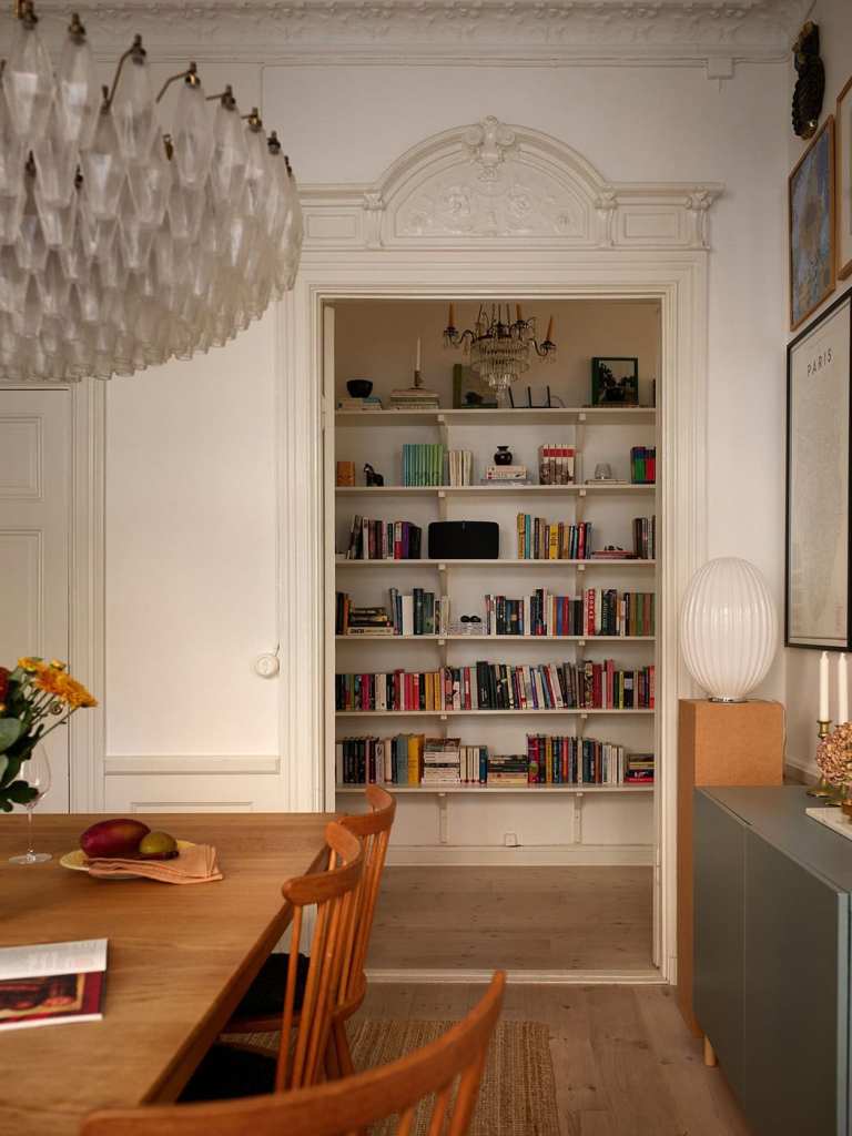 A dining room with a vintage dining table and an impressive gallery wall