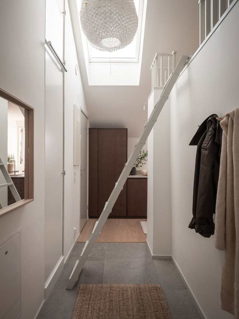 A loft bed that can be accessed through a ladder in the hallway 