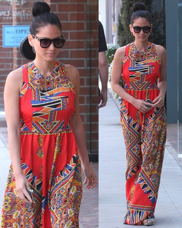 Olivia Munn stuns in a vibrant, patterned maxi dress paired with oversized sunglasses and a sleek updo