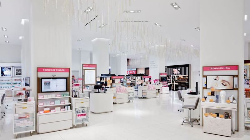 A quiet scene from the Nordstrom 57th Street store beauty floor features snow-white floors, pillars, and ceilings, and glossy white displays. Signs say "Skincare Finder" and "Trending Now."