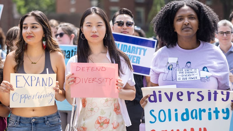 A group of protesters holding signs