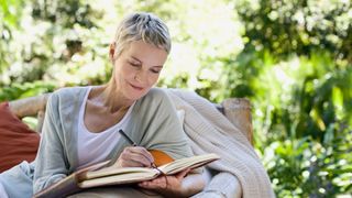 A woman writing in a diary