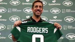 New York Jets quarterback Aaron Rodgers poses with a jersey during an introductory press conference at Atlantic Health Jets Training Center on April 26, 2023 in Florham Park, New Jersey.