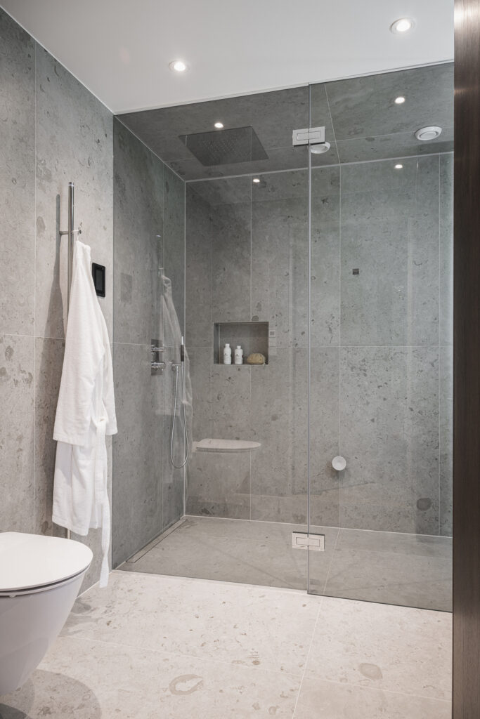 Grey limestone on the floors, walls and shower ceiling