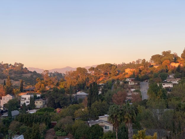 View from Mt. Washington, LA. Sunrise on the far hills and houses in near shadow