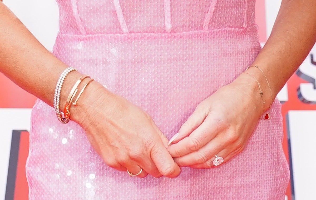 Amanda Holden adds extra sparkles to her look with a tennis bracelet, a gold bangle, dainty chain bracelets, and diamond rings