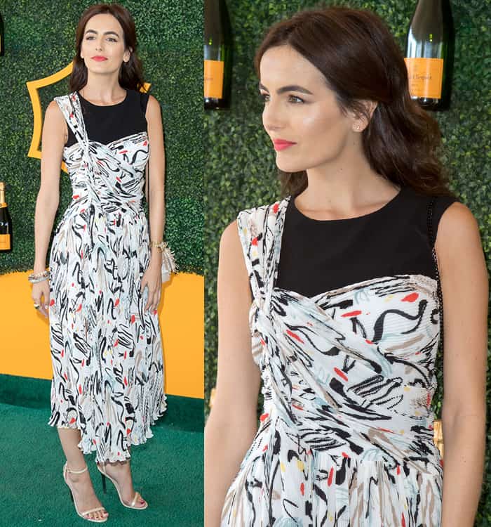 Camilla Belle's outfit featured a unique one-shoulder design with psychedelic-like prints and a ruched bodice, accentuated by a daring thigh-high slit that added an element of allure to her appearance at the 7th Annual Veuve Clicquot Polo Classic