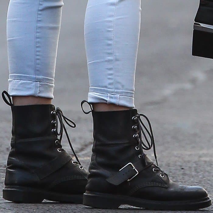 Daisy Lowe steps out in classic black Dr. Martens 1460 boots, pairing them effortlessly with white skinny jeans for a chic, casual look